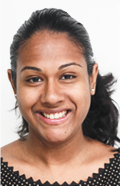 A young woman with medium brown skin and long dark hair pulled back, smiling at the camera, wearing a black top with a patterned neckline and small stud earrings, represents the promise of global education for girls, against a plain white background.