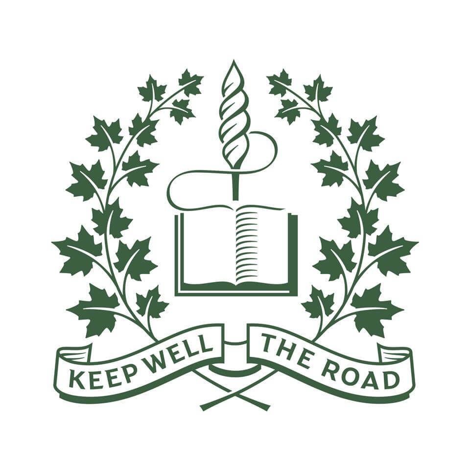 A green emblem featuring a caduceus atop an open book, surrounded by maple leaves, symbolizes global education for girls. Below, a banner reads “KEEP WELL THE ROAD.”.