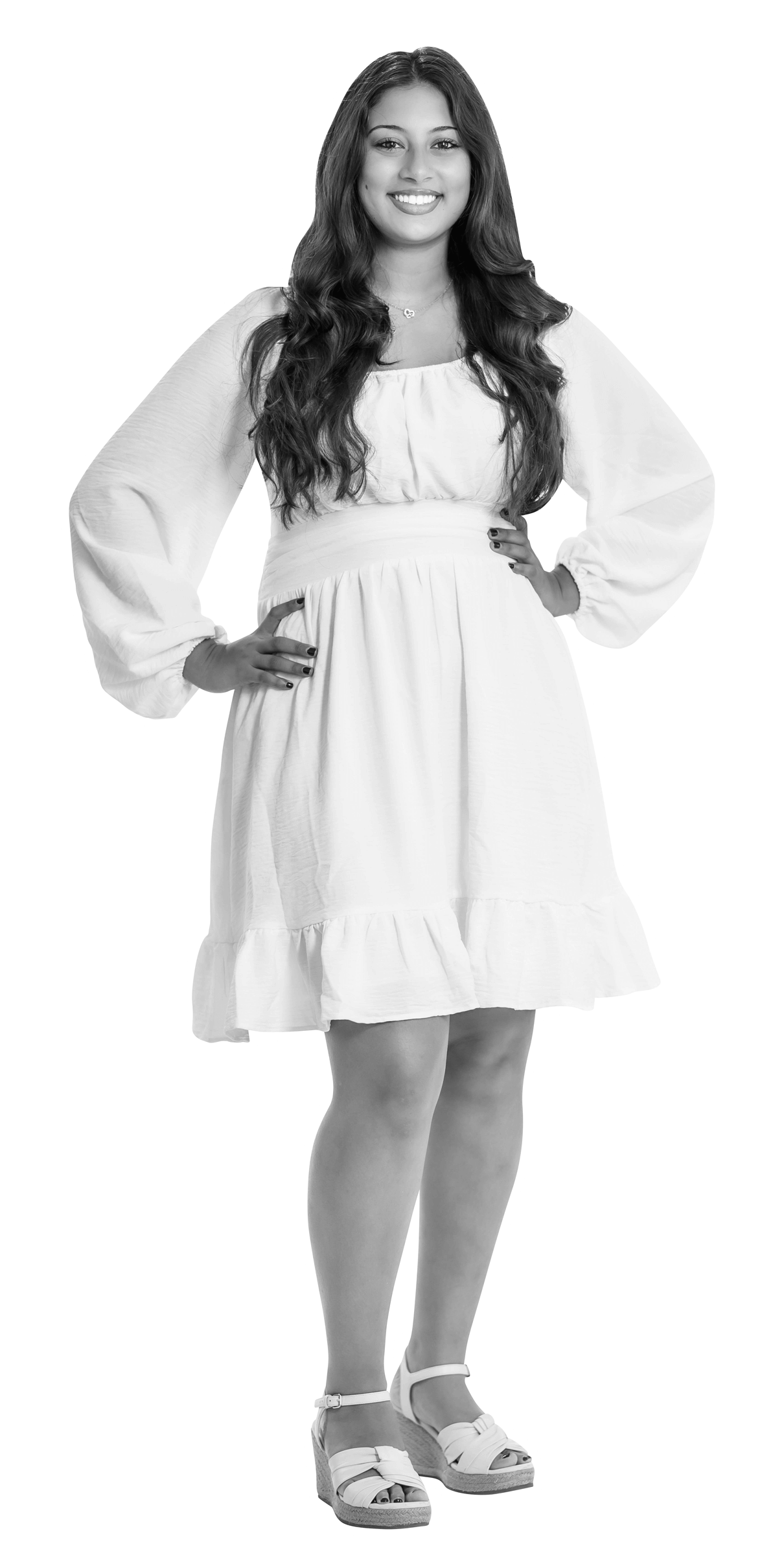 A young woman with long hair stands smiling, wearing a light-colored, long-sleeved dress with ruffles and platform sandals. Her hands rest on her hips. The image is in black and white with a white outline around her.