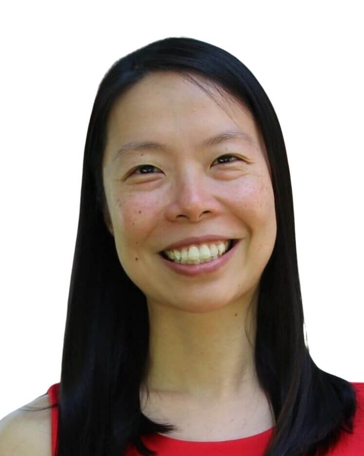 A woman with long straight black hair, wearing a sleeveless red top, smiles at the camera against a plain white background.