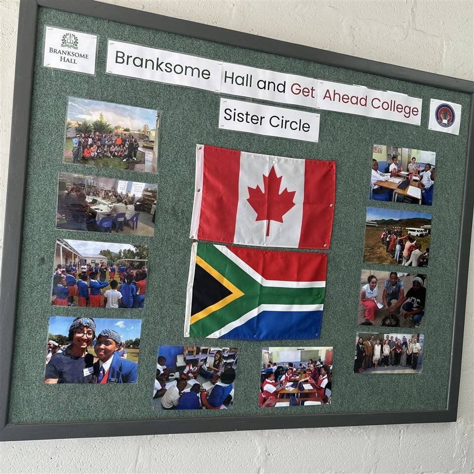 A bulletin board displays "Branksome Hall and Get Ahead College Sister Circle" with Canadian and South African flags, and several photos of students and group activities.