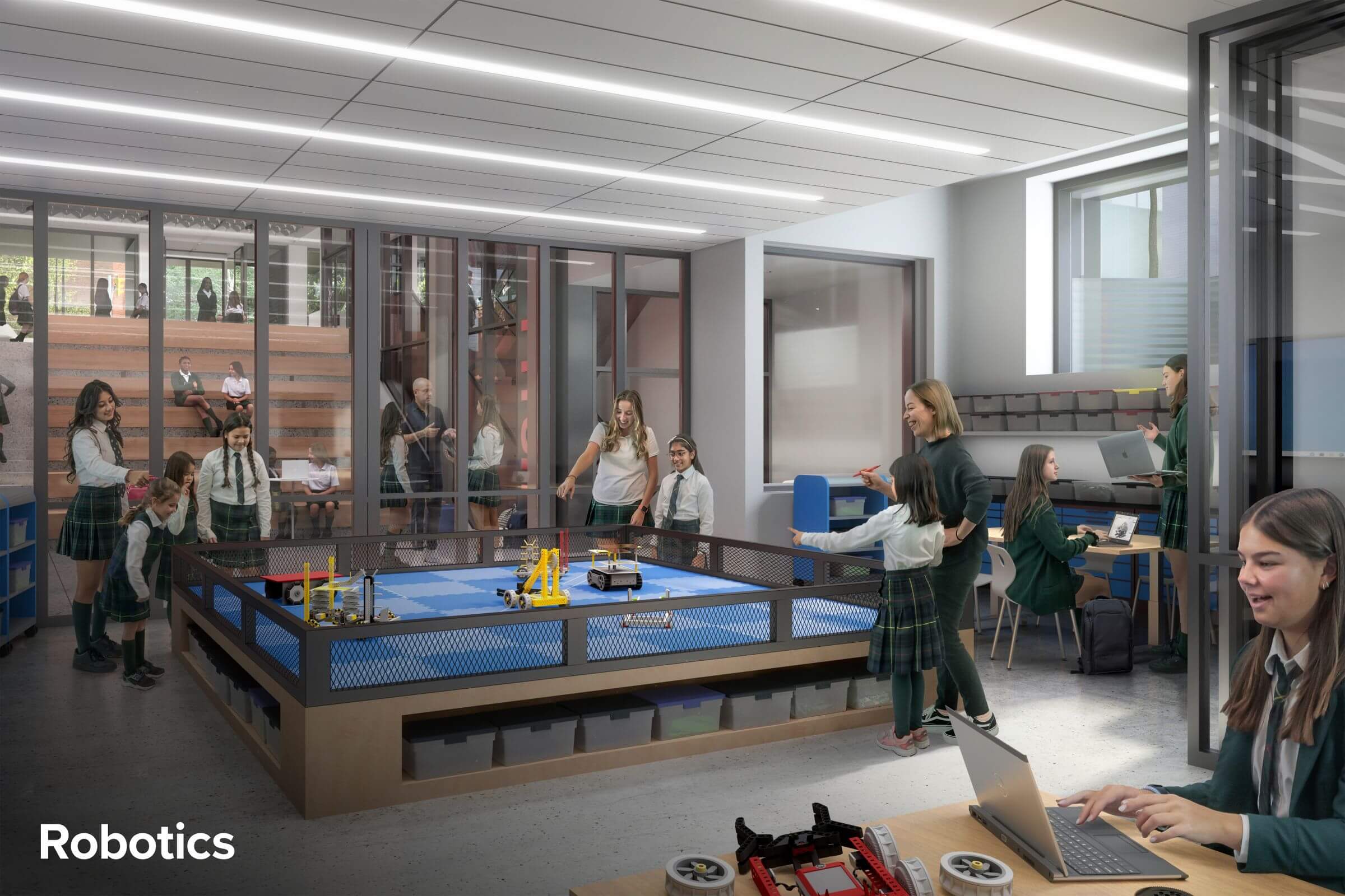 Students and teachers in a modern classroom work on robotics projects; some interact around a robotics competition table, while others use laptops. Large windows and glass walls create an open, collaborative environment. The word "Robotics" appears.