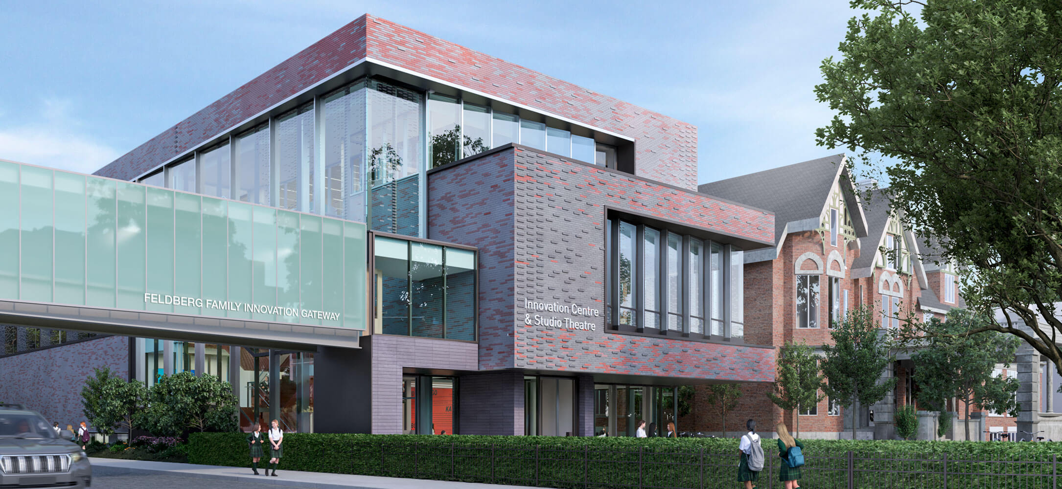 A modern brick and glass building with large windows and a glass walkway labeled "Feldberg Family Innovation Gateway," next to an older brick structure, with people walking and greenery in the foreground.