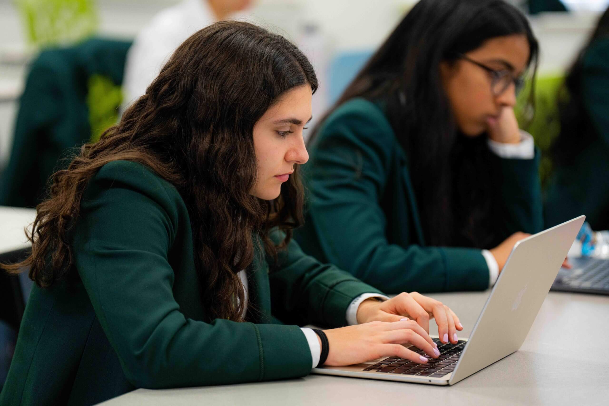 Grade 9 student working on a laptop