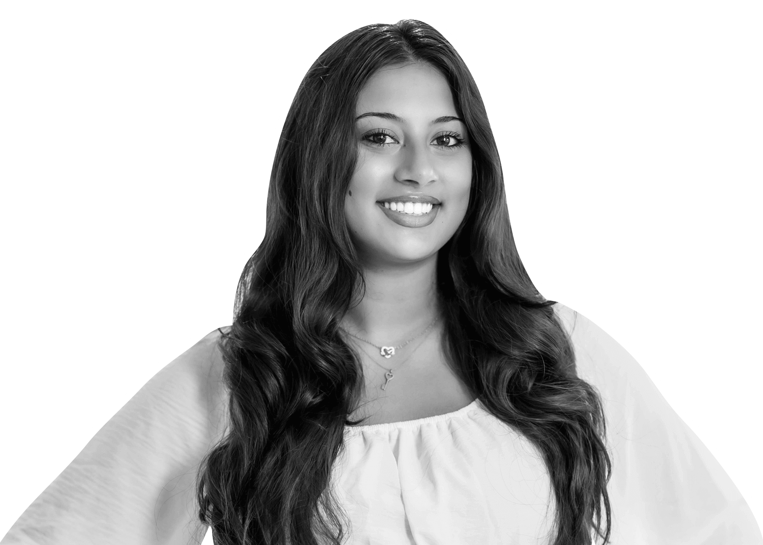A woman with long, wavy hair, wearing a light-colored, off-the-shoulder top and a necklace, smiles at the camera. The photo is in black and white with a white outline around her figure.