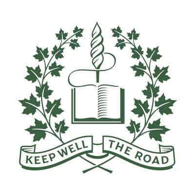 A green emblem featuring a book, a torch, and maple leaves, with a ribbon below displaying the words "KEEP WELL THE ROAD.