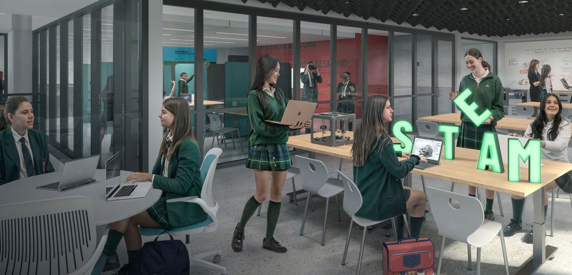 A group of female students in green uniforms work on laptops and projects in a modern classroom. Large glowing letters spelling "STEM" are on a table, and more students and a teacher are visible in the background.